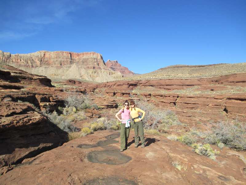 two women posing in front of Grand Canyon rock formations