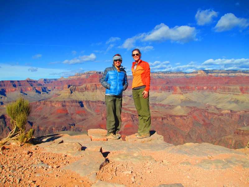couple smiling and posing in front of Grand Canyon view by Pygmy Guides