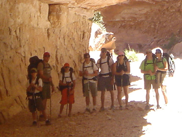 family hiking posing by canyon walls in Grand Canyon