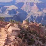 rocky hiking trail with hikers in Grand Canyon