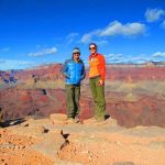 couple smiling and posing in front of Grand Canyon view by Pygmy Guides